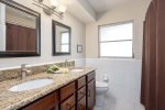 Hallway Bathroom with Double Sinks and Shower Tub Combo